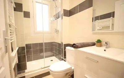 a bathroom with a shower and a toilet and a sink at Lovely 1BR flat 15 min walk from La Croisette in Cannes