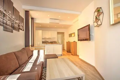 a living room with a couch and a table at Lovely 1BR flat 15 min walk from La Croisette in Cannes