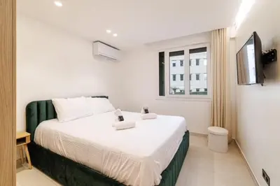 a bedroom with a bed with white sheets and a window at Modern apartment in Cannes 6 people in Cannes