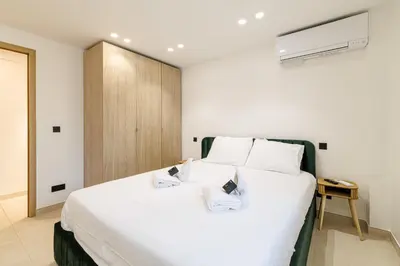 a bedroom with a large white bed with two pillows at Modern apartment in Cannes 6 people in Cannes