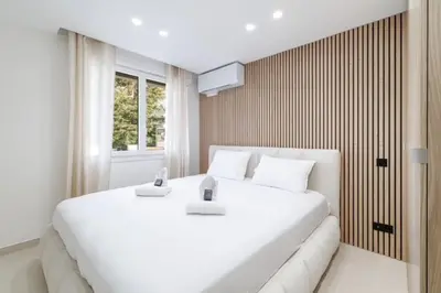 a large white bed in a room with a window at Modern apartment in Cannes 6 people in Cannes
