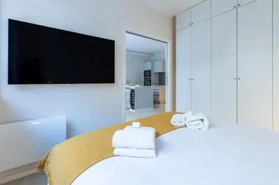 a bedroom with a bed with a tv on the wall at Modern 2 Chambres-TERRASSE-POINTE CROISTTE-PALM BEACH A2B267 in Cannes