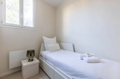 a white bed in a room with a window at Modern 2 Chambres-TERRASSE-POINTE CROISTTE-PALM BEACH A2B267 in Cannes