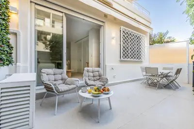 a patio with two chairs and a table with fruit on it at Modern 2 Chambres-TERRASSE-POINTE CROISTTE-PALM BEACH A2B267 in Cannes