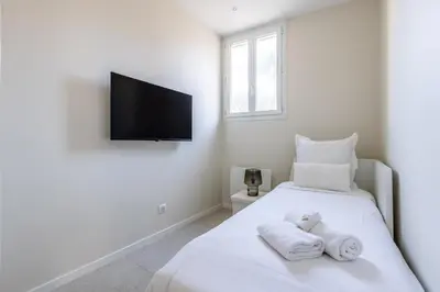 a white bedroom with two towels on a bed at Modern 2 Chambres-TERRASSE-POINTE CROISTTE-PALM BEACH A2B267 in Cannes
