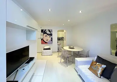 a living room with a couch and a table at Viva Riviera Cocoon Apartment Cannes Centre in Cannes