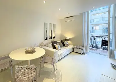 a living room with a couch and a table at Viva Riviera Cocoon Apartment Cannes Centre in Cannes