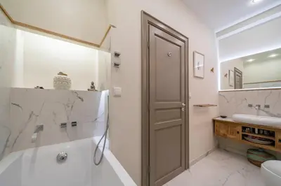 a bathroom with a tub and a sink at COZYSTAY - 1124 - 3-Bedroom Apartment in the Heart of Cannes with Terrace in Cannes