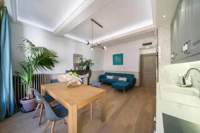 a dining room and living room with a table and chairs at COZYSTAY - 1124 - 3-Bedroom Apartment in the Heart of Cannes with Terrace in Cannes