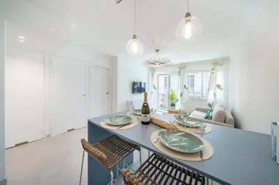 a dining room with a blue table and chairs at Chic appartement 2 pièces in Cannes