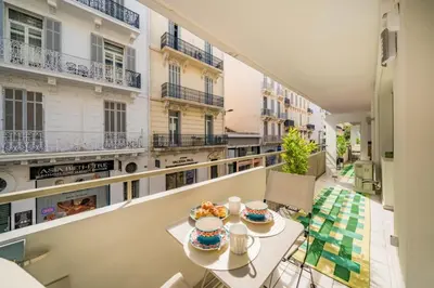 an apartment balcony with a table with food on it at Chic appartement 2 pièces in Cannes