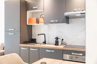 a kitchen with a sink and a counter top at Charming bright studio with spacious outdoor area in Cannes