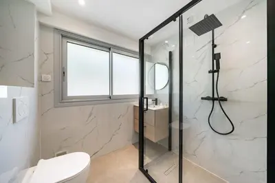 a bathroom with a shower and a toilet at Charming bright studio with spacious outdoor area in Cannes