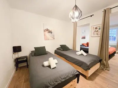 two twin beds in a room with a bedroom at 67m2, cannes vieille-ville, 9min à pied du palais in Cannes