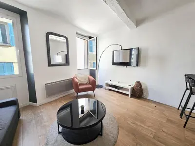 a living room with a couch and a table at 67m2, cannes vieille-ville, 9min à pied du palais in Cannes