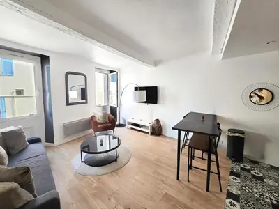 a living room with a couch and a table at 67m2, cannes vieille-ville, 9min à pied du palais in Cannes