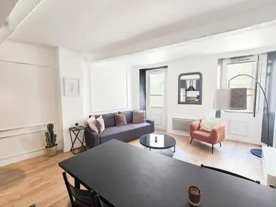 a living room with a couch and a table at 67m2, cannes vieille-ville, 9min à pied du palais in Cannes