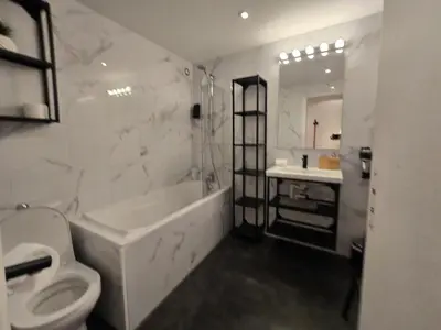 a white bathroom with a toilet and a sink at 67m2, cannes vieille-ville, 9min à pied du palais in Cannes
