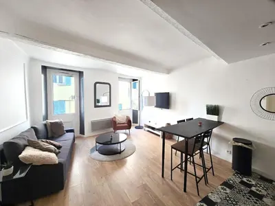 a living room with a couch and a table at 67m2, cannes vieille-ville, 9min à pied du palais in Cannes