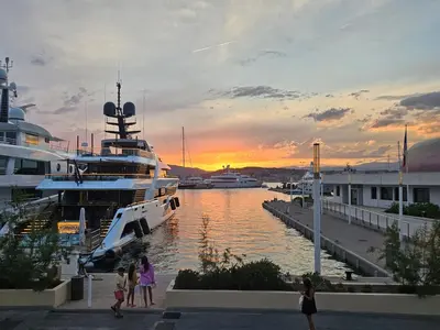 a group of people walking around a marina with boats at Superbe Cannes Palm Beach - Luxury renovation - 4 pers in Cannes