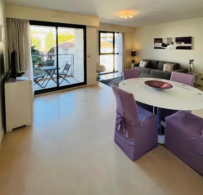 a living room with a table and a couch at Residence Carlton Riviera in Cannes