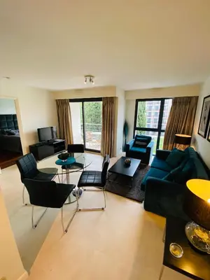 a living room with a blue couch and chairs at Residence Carlton Riviera in Cannes