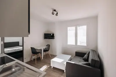 a living room with a couch and a table at Cozy 2-bedroom apartment - Close to Palais, Croisette in Cannes