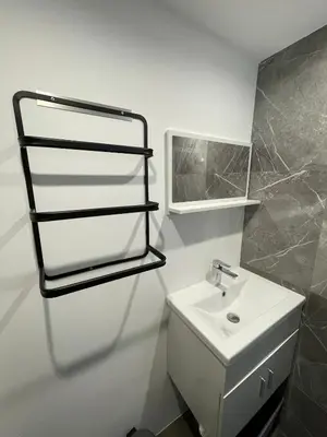 a white bathroom with a sink and a mirror at Cozy 2-bedroom apartment - Close to Palais, Croisette in Cannes