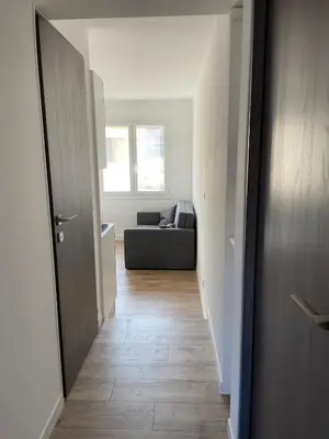 a hallway leading to a living room with a couch at Cozy 2-bedroom apartment - Close to Palais, Croisette in Cannes