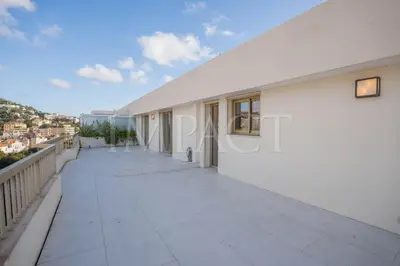 a balcony of a white building with a view at REF 2027 - Cannes Centre - Apartment for Rent in Cannes