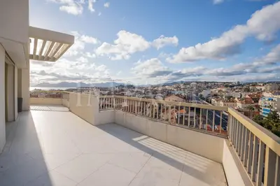 a balcony with a view of a city at REF 2027 - Cannes Centre - Apartment for Rent in Cannes
