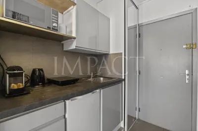 a kitchen with white cabinets and a sink at Cannes Croisette - 2035 Studio For rent in Cannes