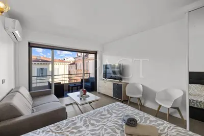 a living room with a couch and a bed and a television at Cannes Croisette - 2035 Studio For rent in Cannes