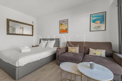 a hotel room with a bed and a couch at Cannes Croisette 2034 - Studio for rent in Cannes