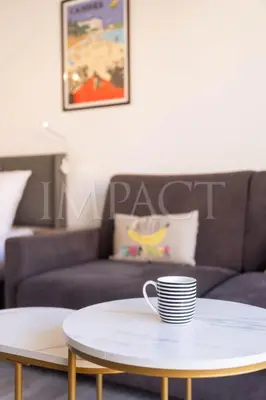 a coffee table in a living room with a couch at Cannes Croisette 2034 - Studio for rent in Cannes