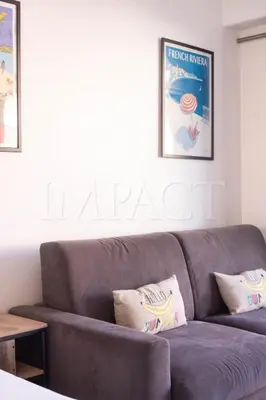a couch in a living room with two pillows at Cannes Croisette 2034 - Studio for rent in Cannes