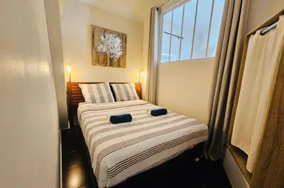 a small bedroom with a bed with a window at Bright apartment in Cannes for 5 people in Cannes
