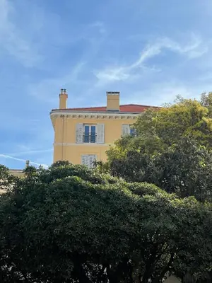 a yellow building with trees in front of it at Bright apartment in Cannes for 5 people in Cannes