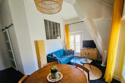 a living room with a table and a blue couch at Bright apartment in Cannes for 5 people in Cannes