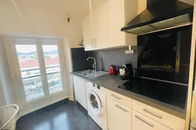 a kitchen with a sink and a stove top oven at Bright apartment in Cannes for 5 people in Cannes
