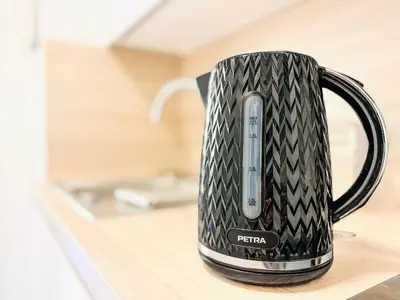 a black coffee mug sitting on a kitchen counter at Cannes Estello - Comfortable accommodation Terrace Parking in Cannes