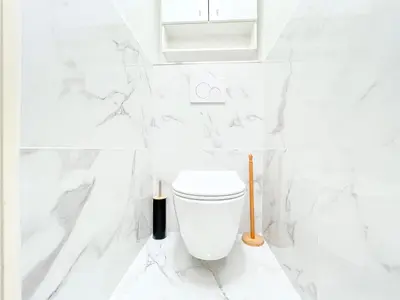a white bathroom with a white toilet in it at Cannes Estello - Comfortable accommodation Terrace Parking in Cannes