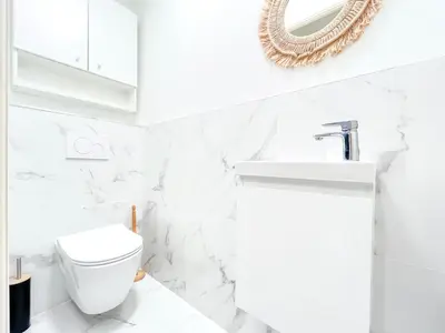 a white bathroom with a toilet and a sink at Cannes Estello - Comfortable accommodation Terrace Parking in Cannes
