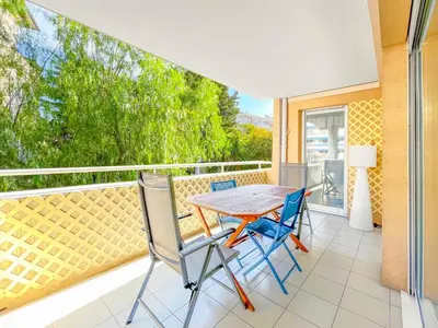 a patio with a table and chairs on a balcony at Cannes Estello - Comfortable accommodation Terrace Parking in Cannes