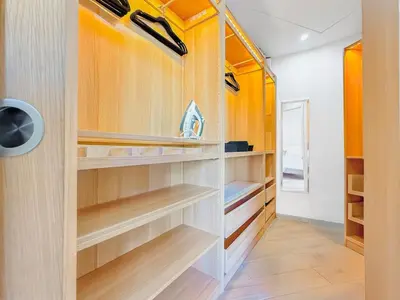 a walk in closet with wooden shelves at Nova - near sea and beaches in Cannes