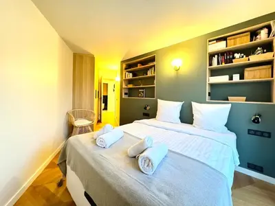 a bedroom with a large bed with towels on it at Le Clemenceau - Cannes Mer Belle Vue in Cannes