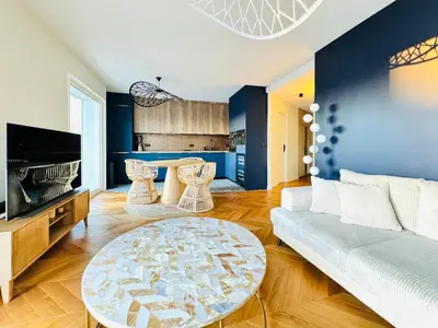 a living room with a couch and a table at Le Clemenceau - Cannes Mer Belle Vue in Cannes