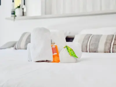 a pile of towels and a bottle of medicine on a bed at Terranova Cannes Terrace Accommodation in Cannes