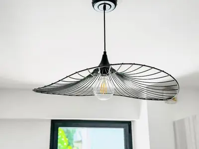 a large glass light fixture hanging from a ceiling at Terranova Cannes Terrace Accommodation in Cannes