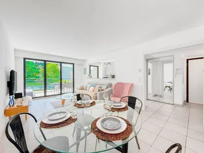 a living room with a glass table and chairs at Terranova Cannes Terrace Accommodation in Cannes